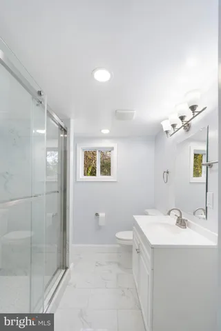 a bathroom with a double vanity sink mirror and shower