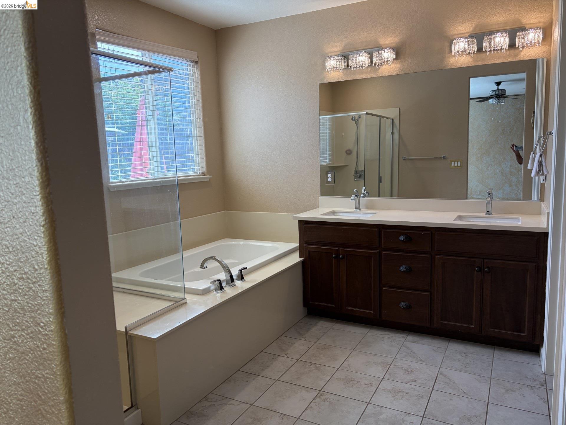 809 Ibis Road Oakley, CA 94561 - Photo 25 of 32 Dual vanity with white undermount sinks, brown wood-finish cabinetry, and polished chrome faucets