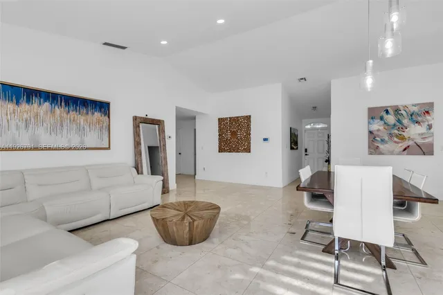 a living room with furniture and a painting