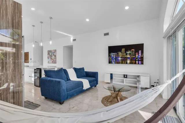 a living room with furniture and a flat screen tv