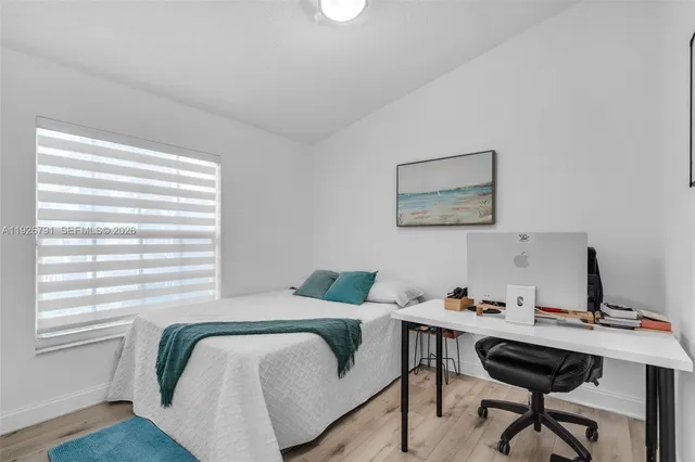 a bedroom with a bed and a desk