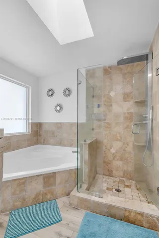 a bathroom with a bathtub and a shower