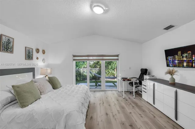 a bedroom with a bed and a desk