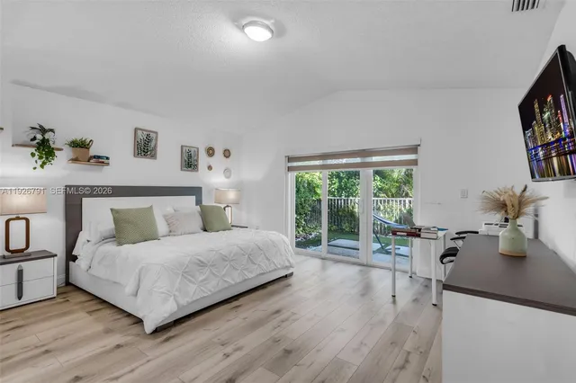 a bedroom with a bed and a large window