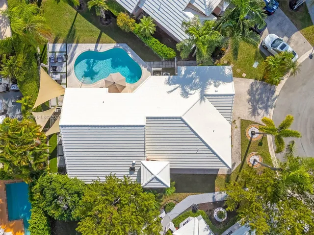 a view of a backyard with plants and a patio