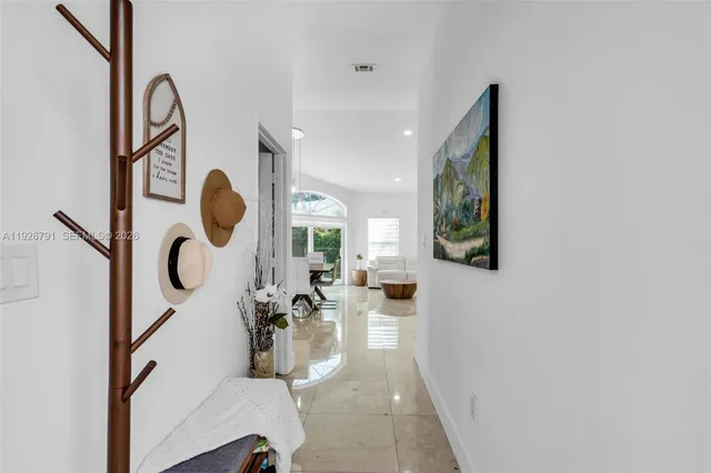 a living room with furniture and floor to ceiling window