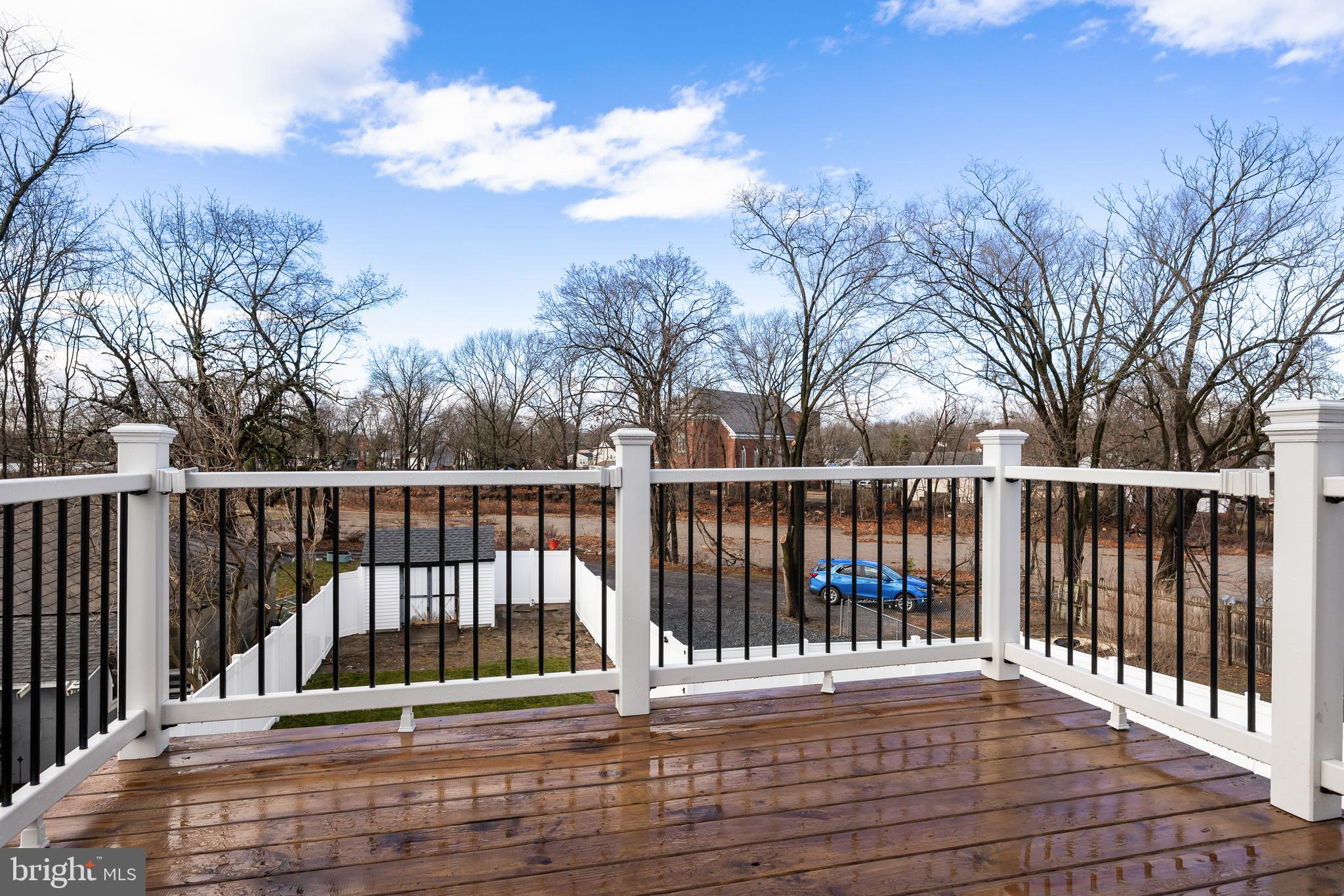52 Madison Avenue Mount Holly, NJ 08060 - Photo 26 of 53 a view of balcony with wooden floor and fence and trees
