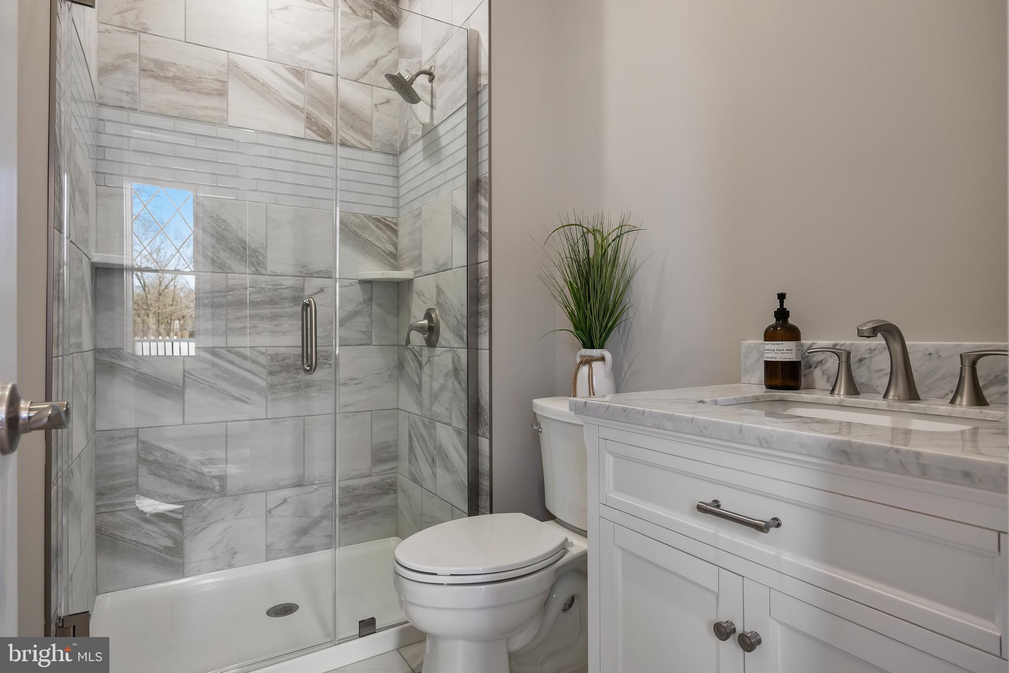 52 Madison Avenue Mount Holly, NJ 08060 - Photo 29 of 53 a bathroom with a sink a toilet and shower