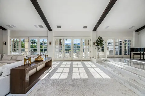 a large white kitchen with lots of counter space sink and appliances