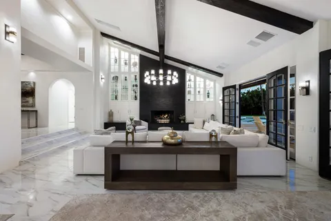 a kitchen with stainless steel appliances granite countertop a sink a stove and a wooden cabinets