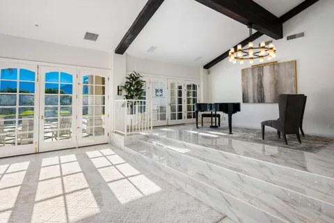 a living room with a large bed and a fireplace