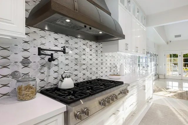 a bedroom with a bed lamp and a flat tv screen