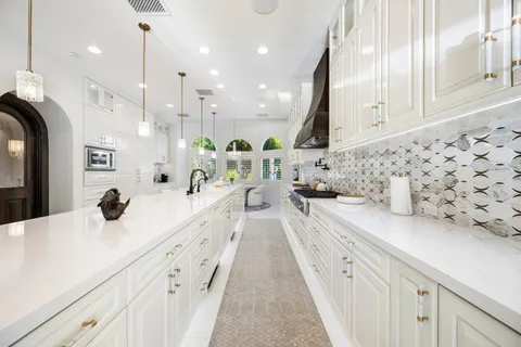 a bathroom with a bathtub shower sink vanity mirror and toilet