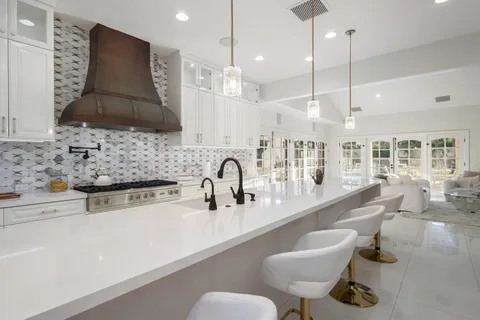 a kitchen with stainless steel appliances granite countertop a stove and a sink