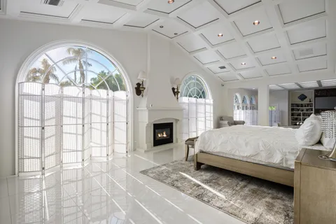 a bedroom with a bed and a fireplace