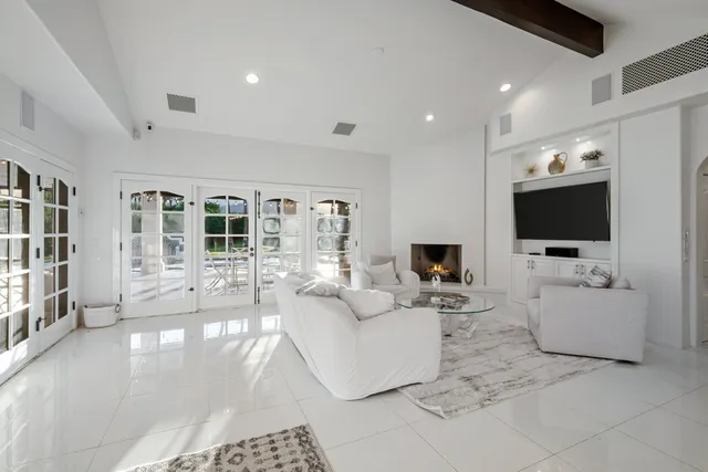 a bed sitting in a spacious bedroom next to a window