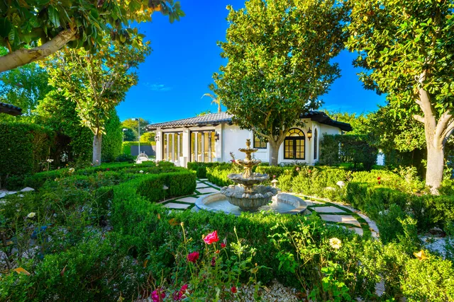 a view of a patio with table and chairs and a barbeque