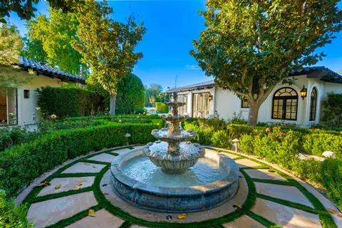 a view of a patio with a table and chairs under an umbrella