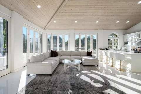 a view of a house with swimming pool and sitting area