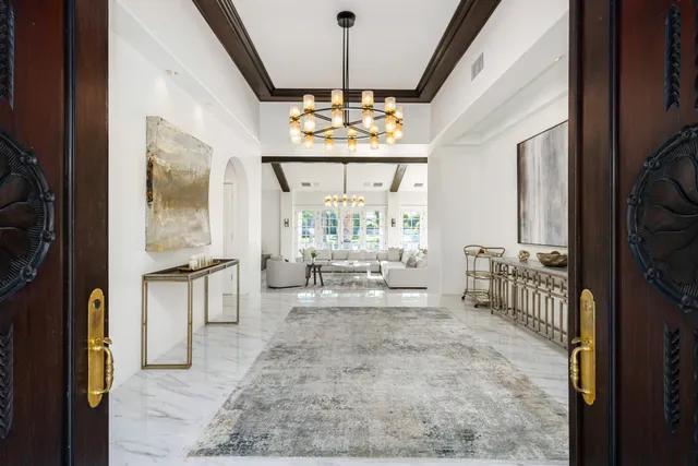 a dining room with furniture a chandelier and window