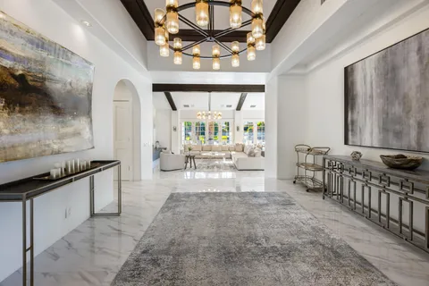 a kitchen with stainless steel appliances a sink a stove and a wooden floors