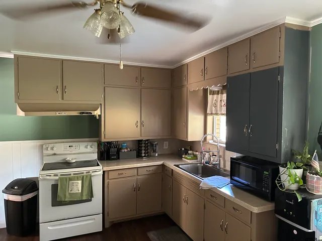 a kitchen with a stove cabinets and a sink