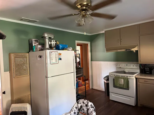 a white refrigerator freezer sitting inside of a kitchen