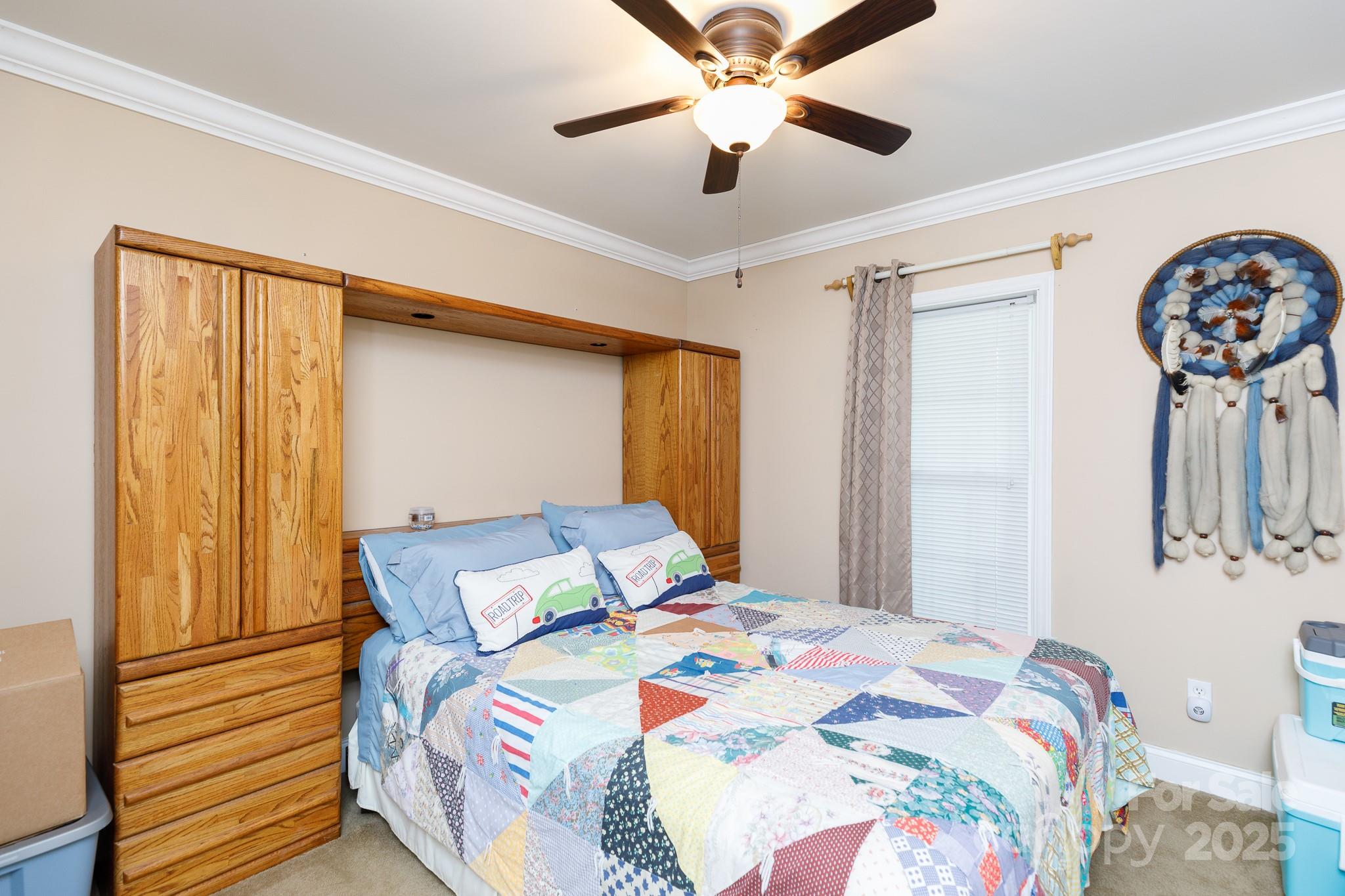 3199 Harmony Road Catawba, SC 29704 - Photo 17 of 46 a bedroom with a bed and a chandelier