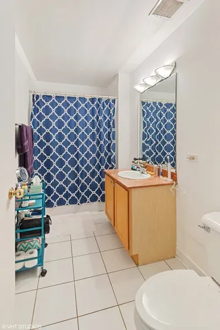 a bathroom with a sink a toilet and a shower