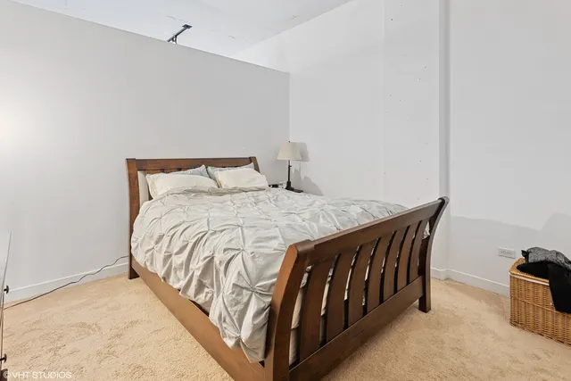 a bed sitting in a bedroom next to a window