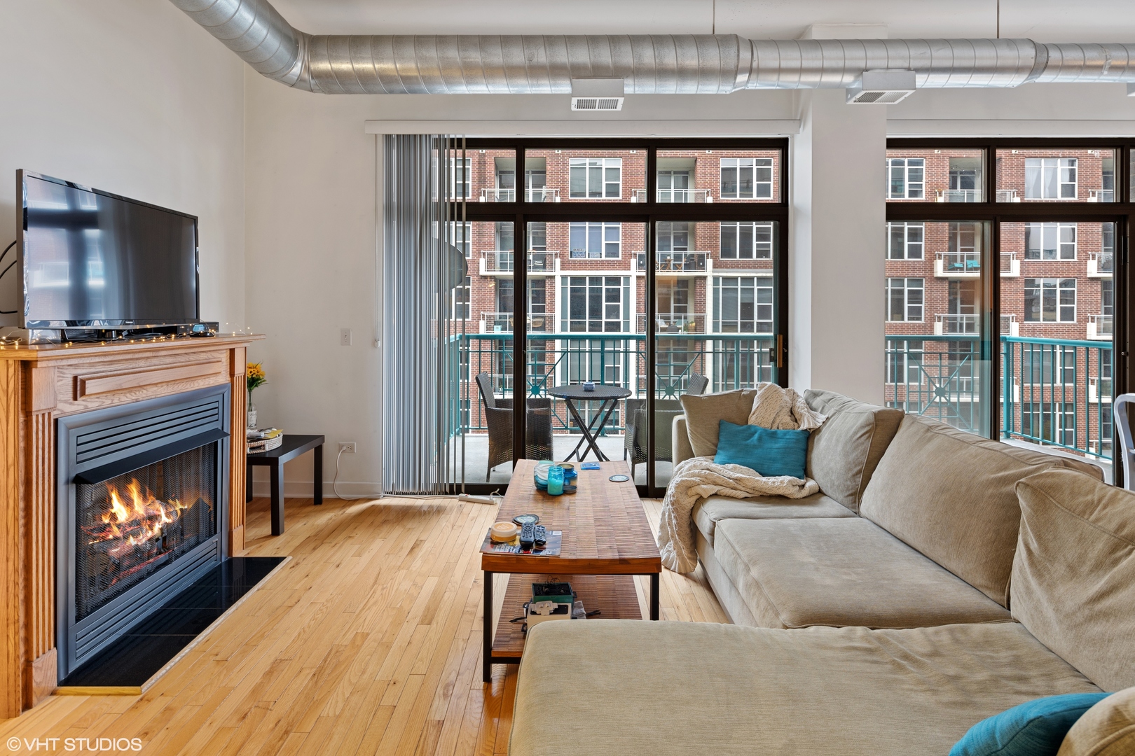 910 West Madison Street, Unit 603 Chicago, IL 60607 - Photo 3 of 15 a living room with furniture large window and a fireplace