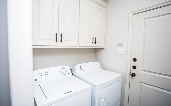 a view of storage and utility room with washer and dryer