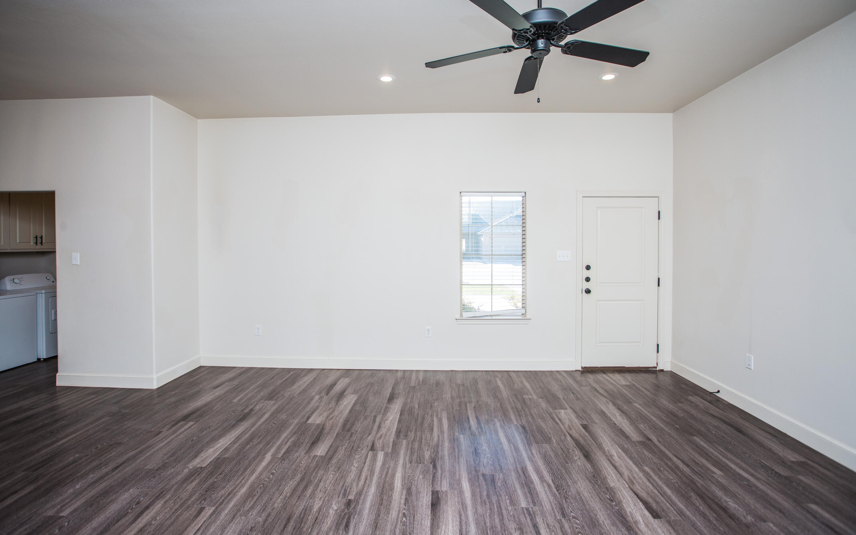 5520 Lehigh Street Lubbock, TX 79416 - Photo 12 of 32 a view of a room with wooden floor and a ceiling fan
