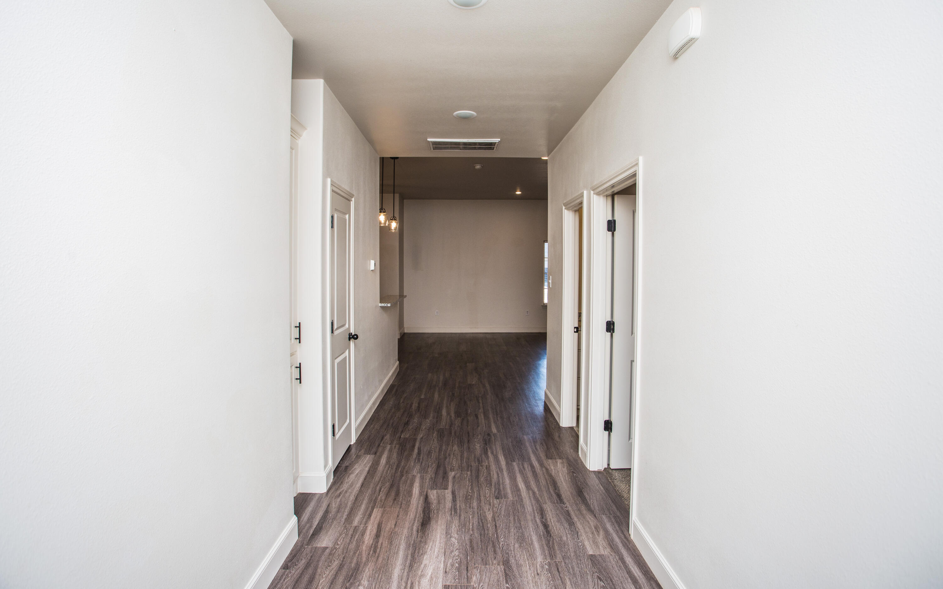 5520 Lehigh Street Lubbock, TX 79416 - Photo 31 of 32 a view of a hallway with wooden floor