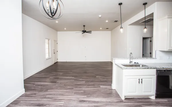 a view of a kitchen with a sink and a stove top oven