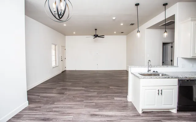 a view of a kitchen with a sink and a stove top oven