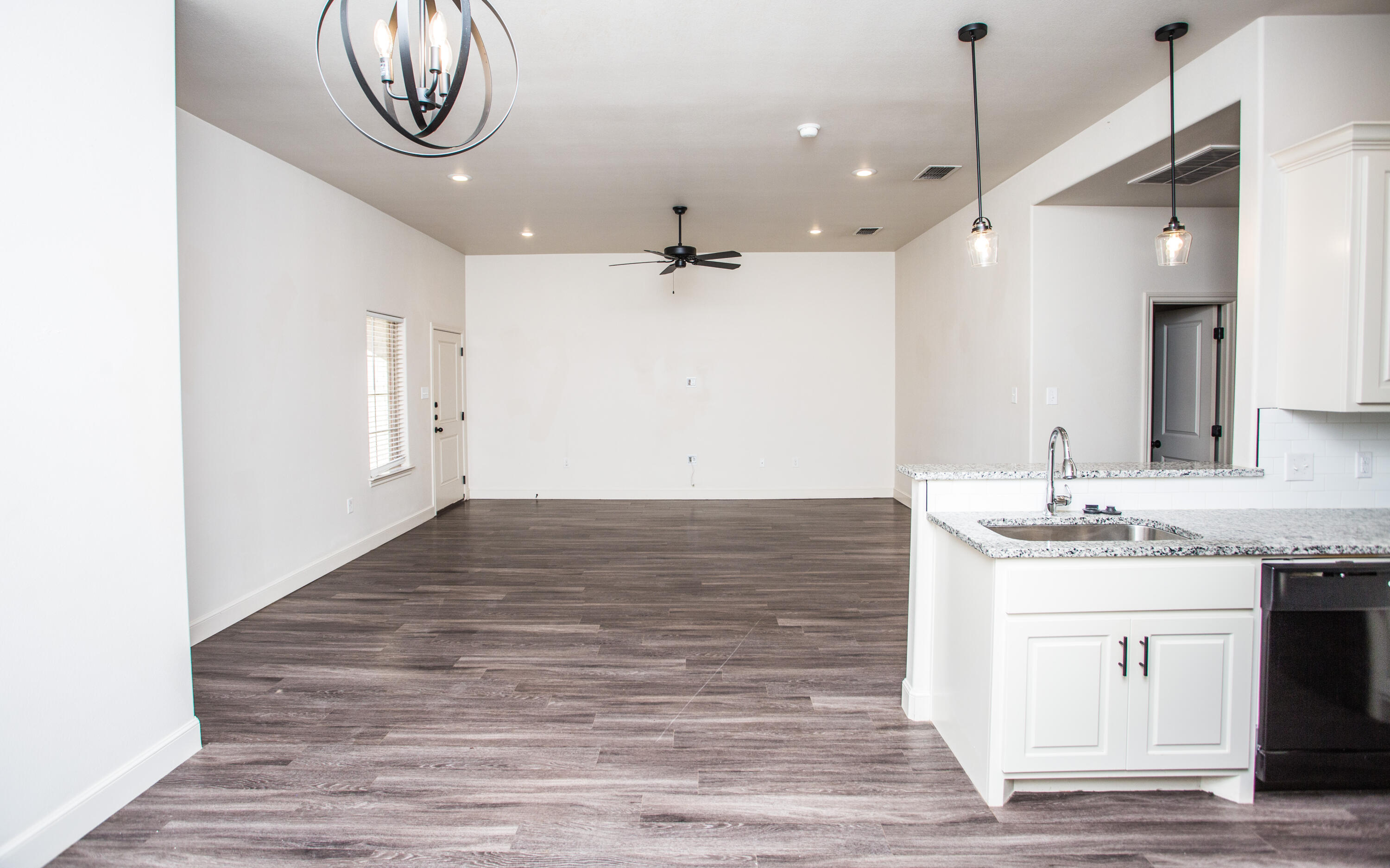5520 Lehigh Street Lubbock, TX 79416 - Photo 6 of 32 a view of a kitchen with a sink and a stove top oven