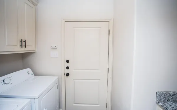 a utility room with a sink dryer and washer