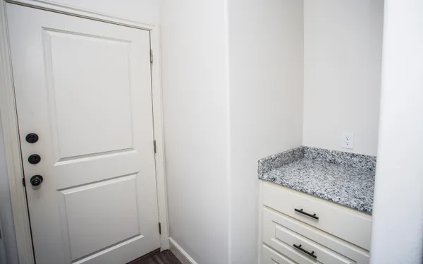 a bathroom with a granite countertop sink and vanity