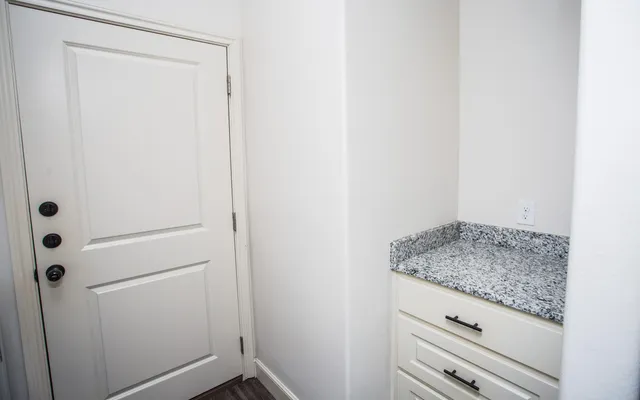 a bathroom with a granite countertop sink and vanity