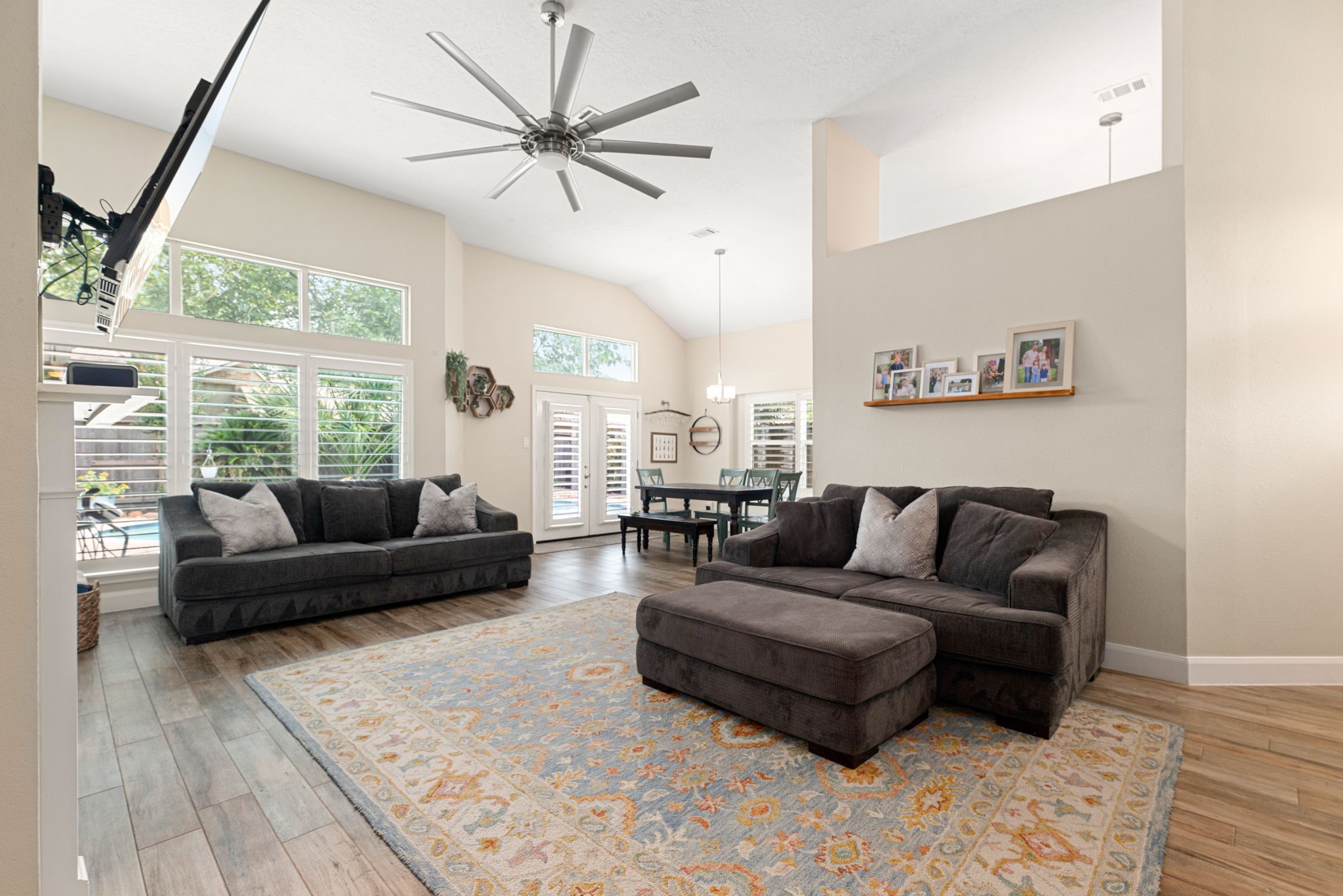 1915 Mercoal Drive Spring, TX 77386 - Photo 8 of 50 Open-concept living room filled with natural light, vaulted ceilings, and ample space for entertaining.