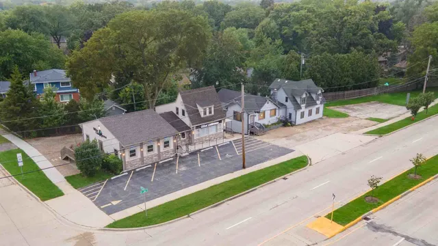 an aerial view of a house with garden space and street view