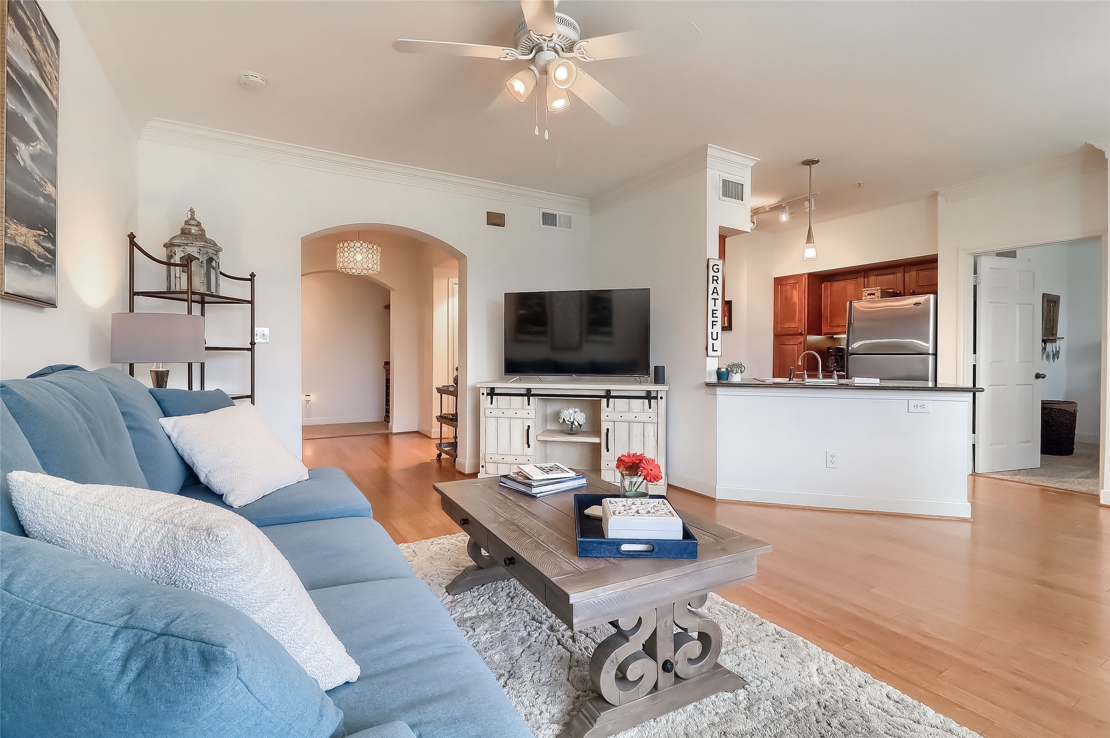 7701 Rialto Boulevard, Unit 1128 Austin, TX 78735 - Photo 3 of 35 a living room with furniture and a flat screen tv
