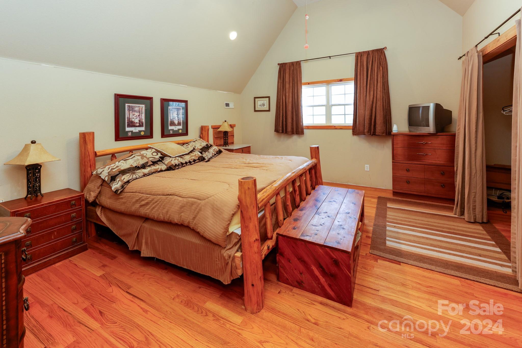 43 Goldfinch Ln Mill Spring Mill Spring, NC 28756 - Photo 27 of 32 a bedroom with a bed and wooden floor