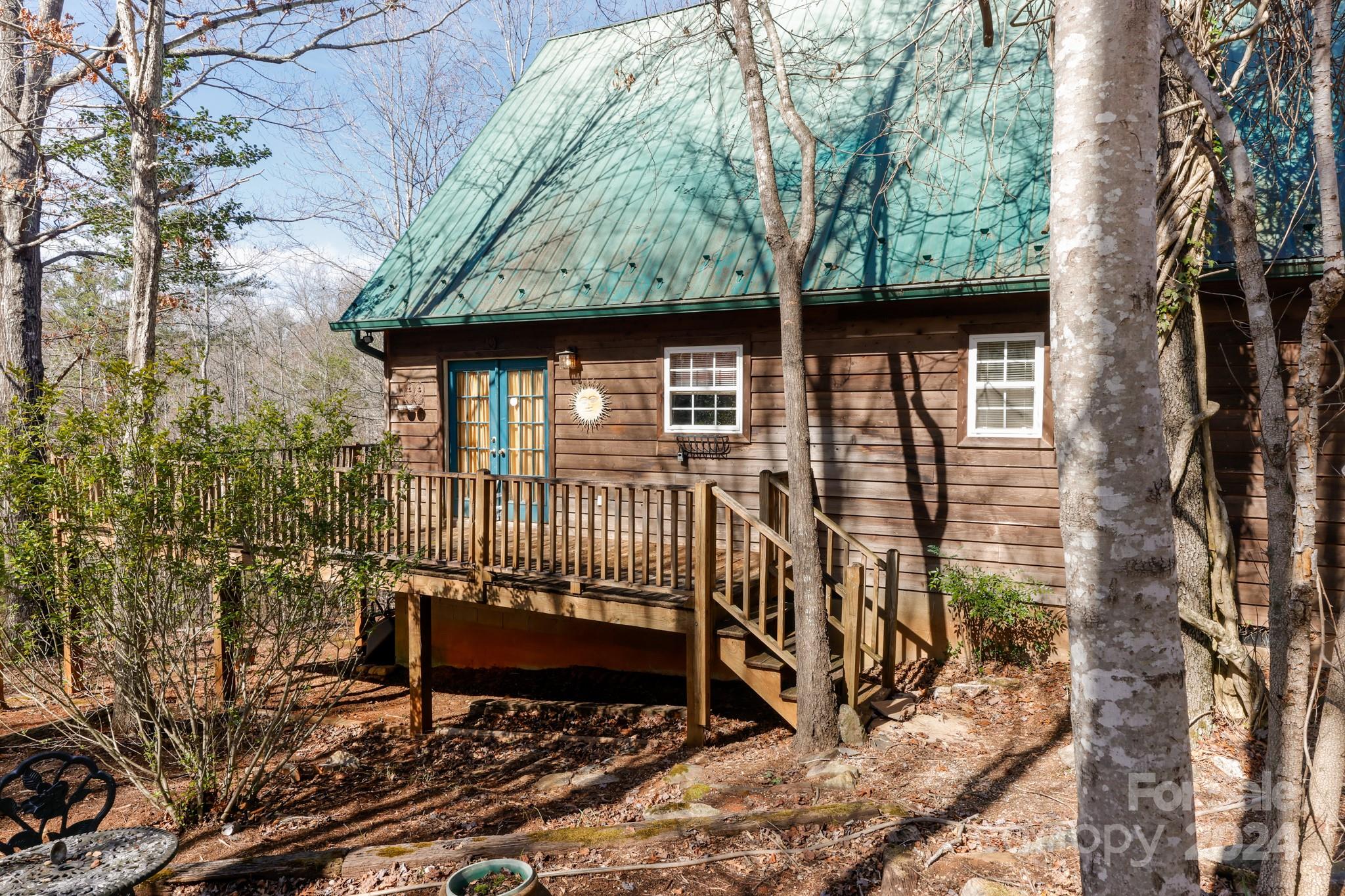 43 Goldfinch Ln Mill Spring Mill Spring, NC 28756 - Photo 3 of 32 a view of a bench in the backyard