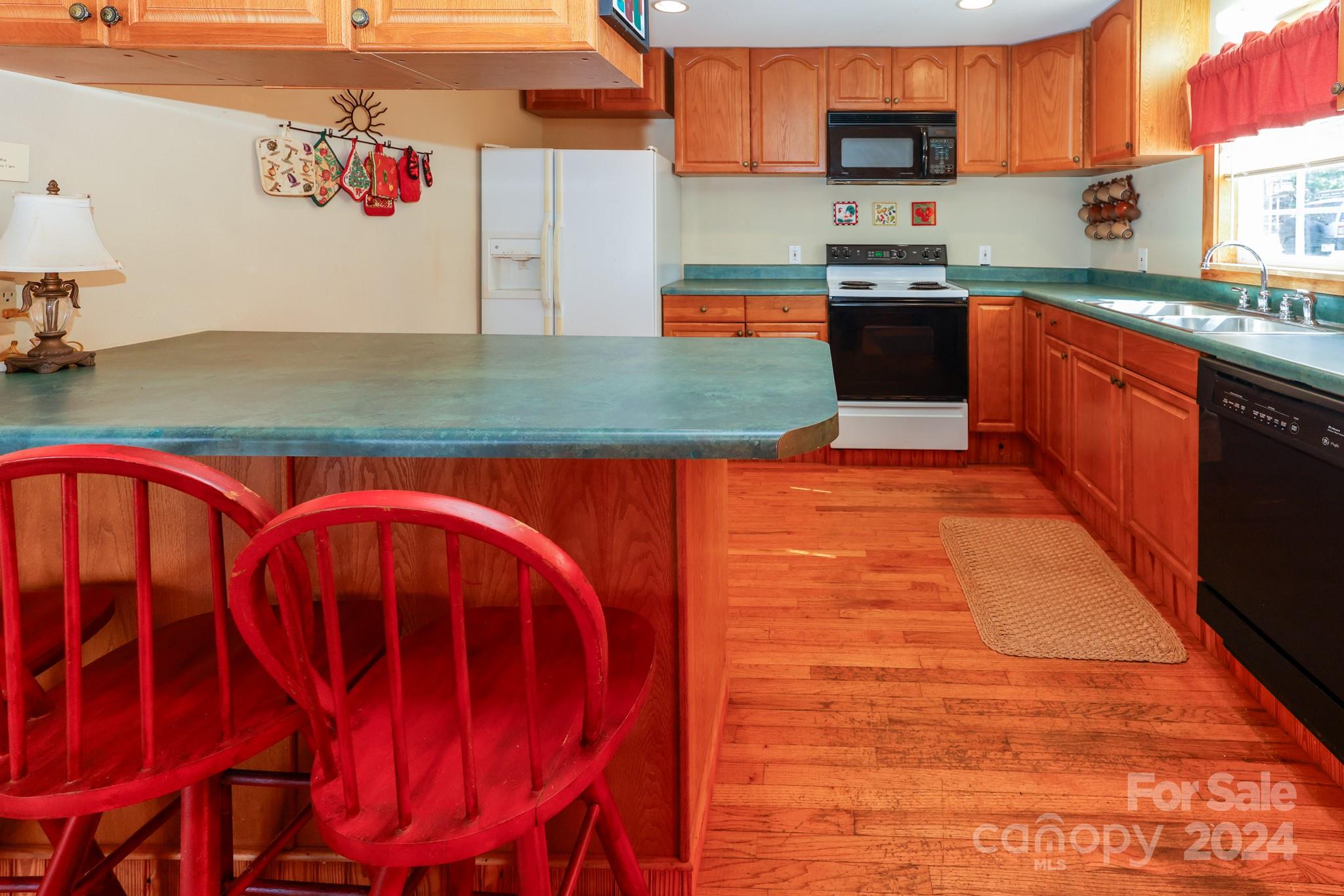 43 Goldfinch Ln Mill Spring Mill Spring, NC 28756 - Photo 10 of 32 a kitchen with stainless steel appliances granite countertop a stove a sink and a microwave