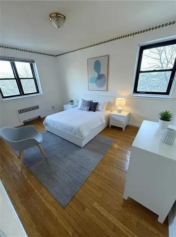 a bedroom with a large bed and a large window