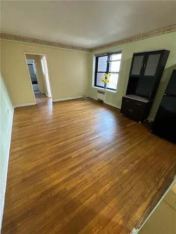 a view of a livingroom with wooden floor and a ceiling fan