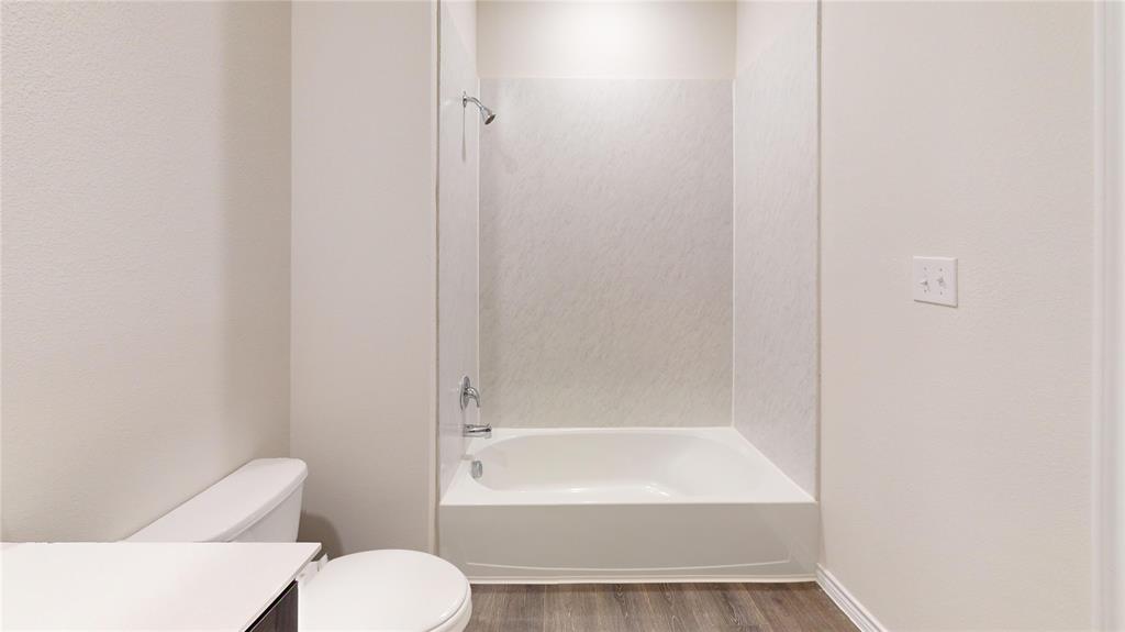 2024 Juniper Pass Way Mesquite, TX 75149 - Photo 13 of 17 a bathroom with a toilet and a bathtub