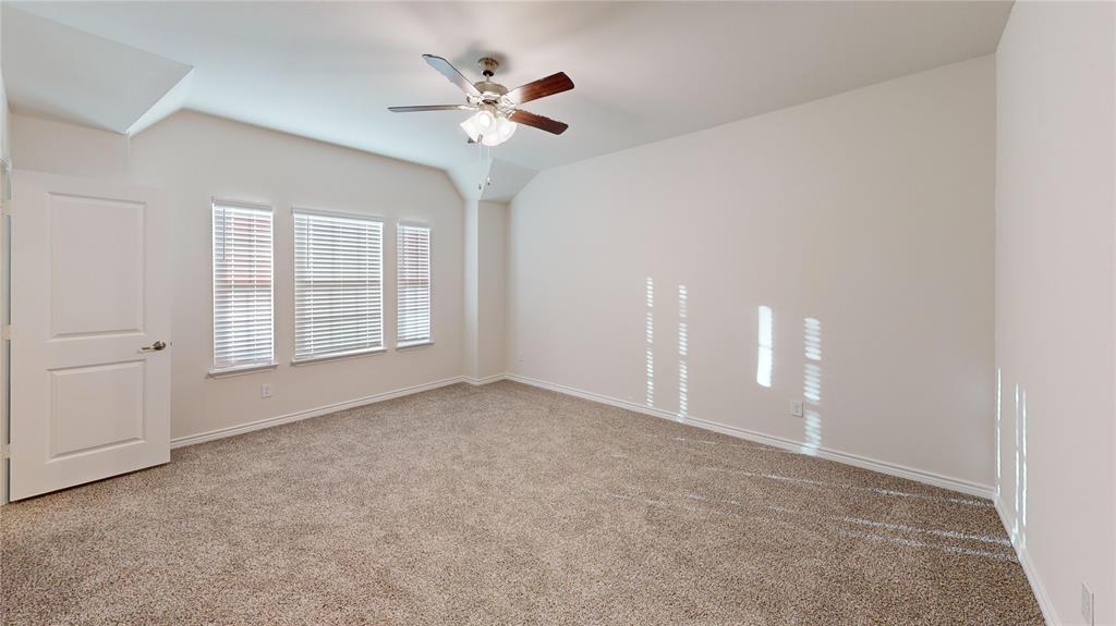 2024 Juniper Pass Way Mesquite, TX 75149 - Photo 14 of 17 a view of an empty room with a chandelier fan